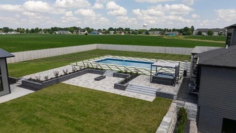 Completed residential landscape architecture project by Beck Engineering featuring a custom pool, modern patio, retaining walls, planting beds, and outdoor living spaces.
